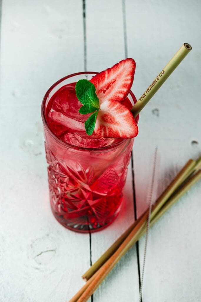 red cocktail with bamboo straw